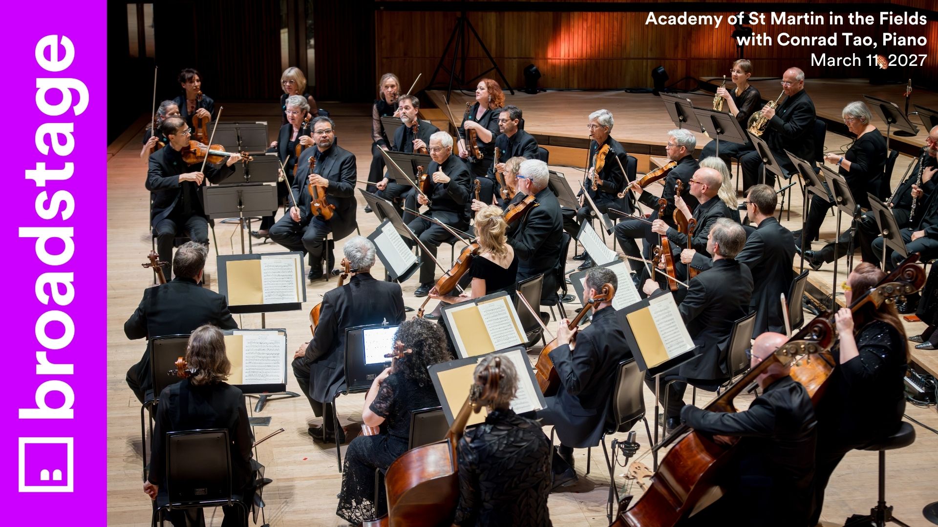 Overhead view of the Academy of St Martin in the Fields orchestra performing on stage in black attire. BroadStage branding and event details appear on the sides.