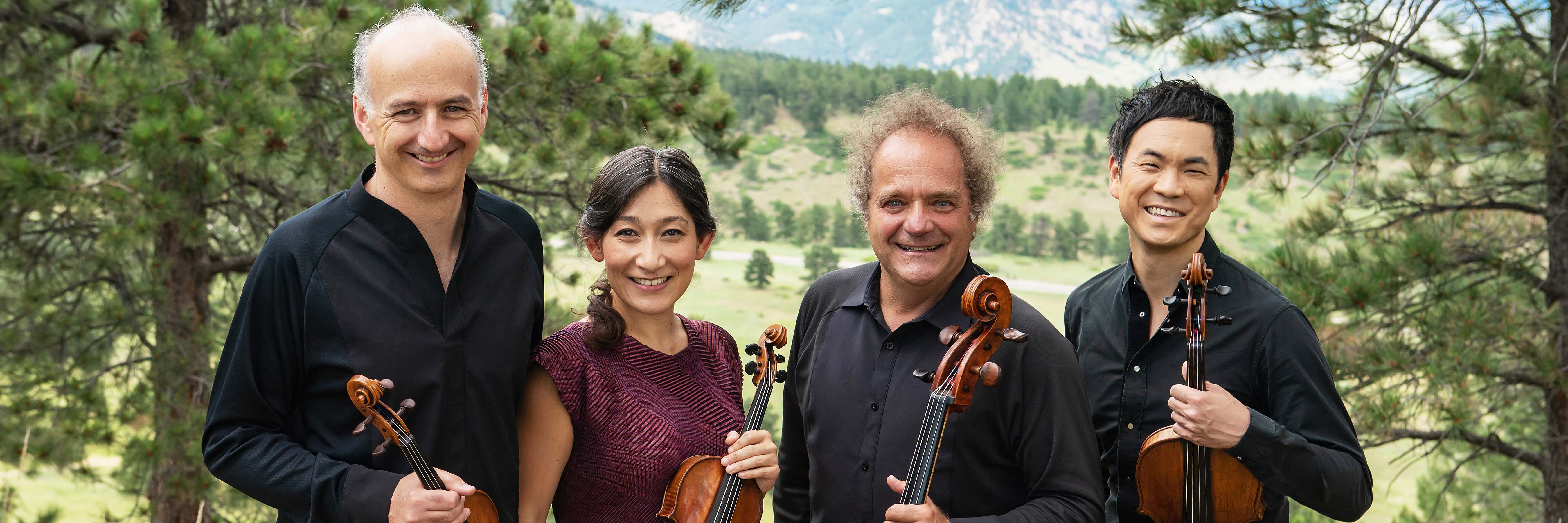 Takacs Quartet holds their instruments outside
