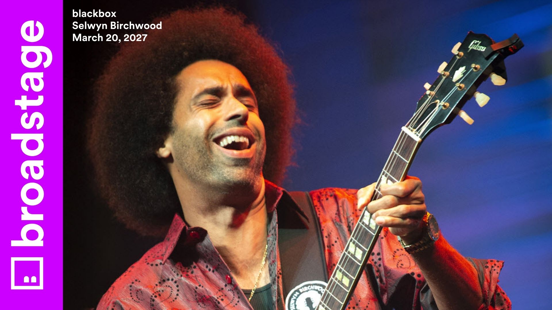Selwyn Birchwood plays electric guitar and laughs with eyes closed under blue stage lighting, wearing a patterned shirt. BroadStage branding and event details appear on the left.